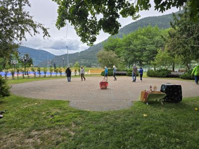 people walking a brick paver labyrinth surrounded by trees