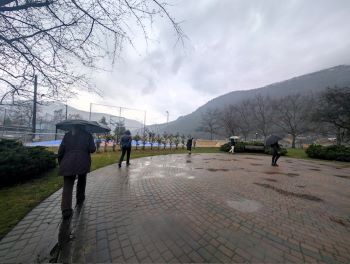 People walking a labyrinth in the rain 