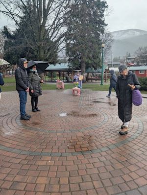 People walking a labyrinth in the rain 