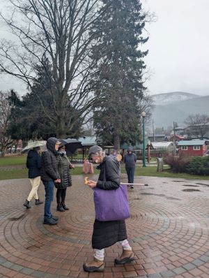 People walking a labyrinth in the rain 
