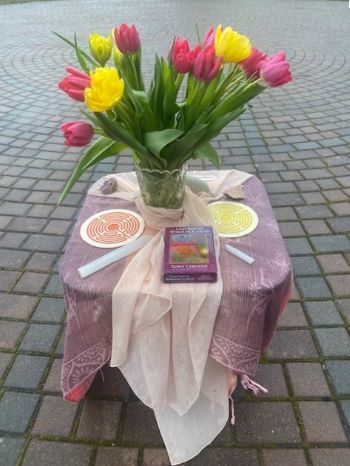 An outdoor altar with pink and yellow flowers 