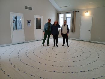 three people walking a cloth labyrinth 